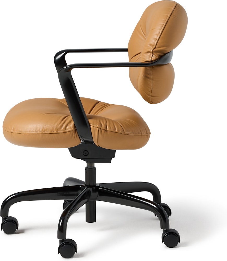 Side view of a Morrison Hannah chair with a black frame and base with fixed arms and light brown leather upholstery.