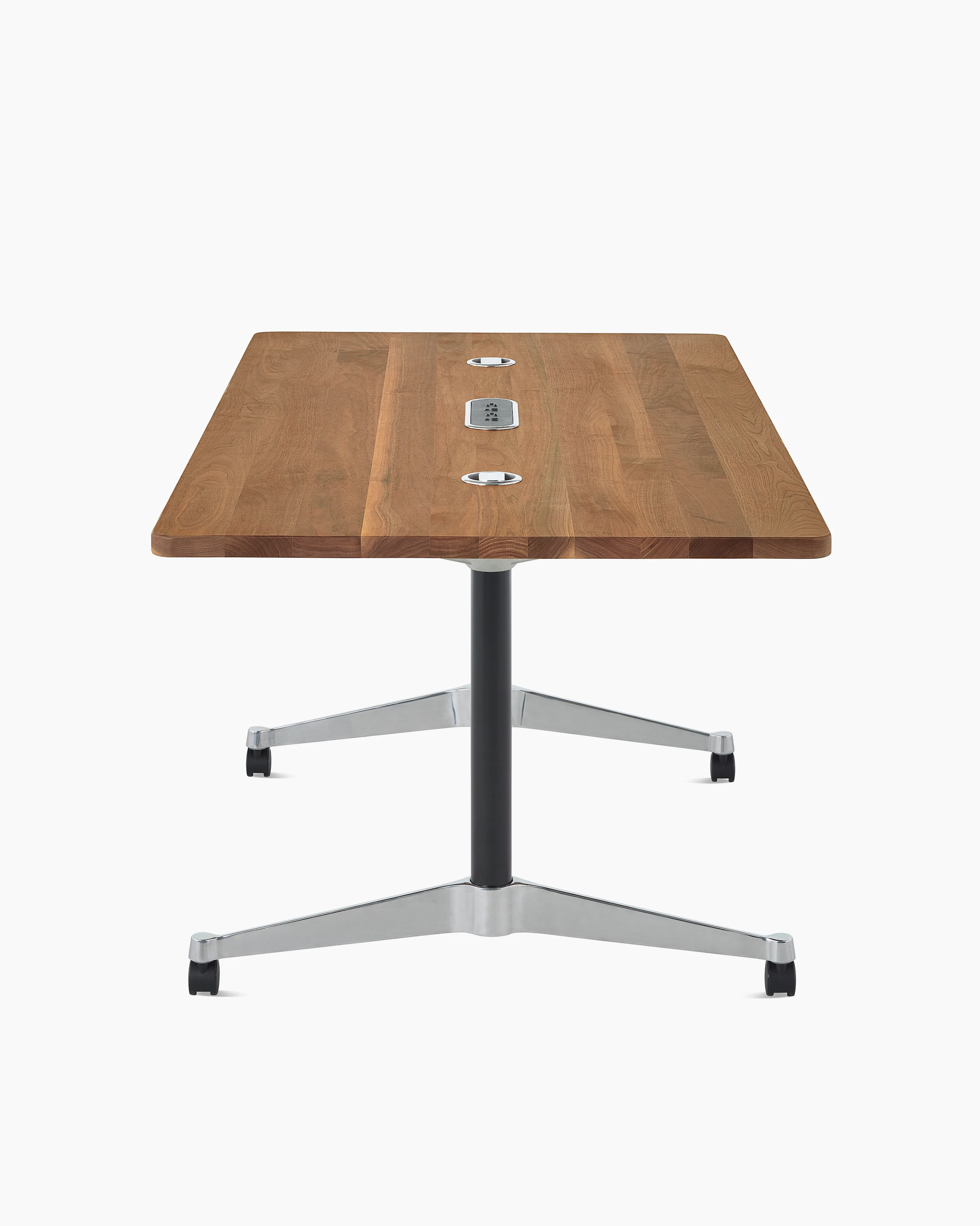 A walnut Eames T-Leg conference table with black legs, chrome feet, power access, and routing capabilities.