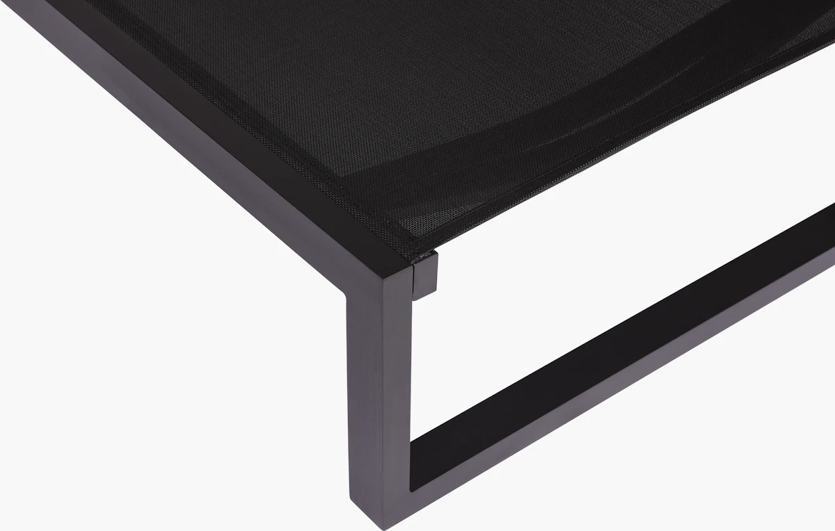 Black outdoor chaise lounge chair in reclined position
