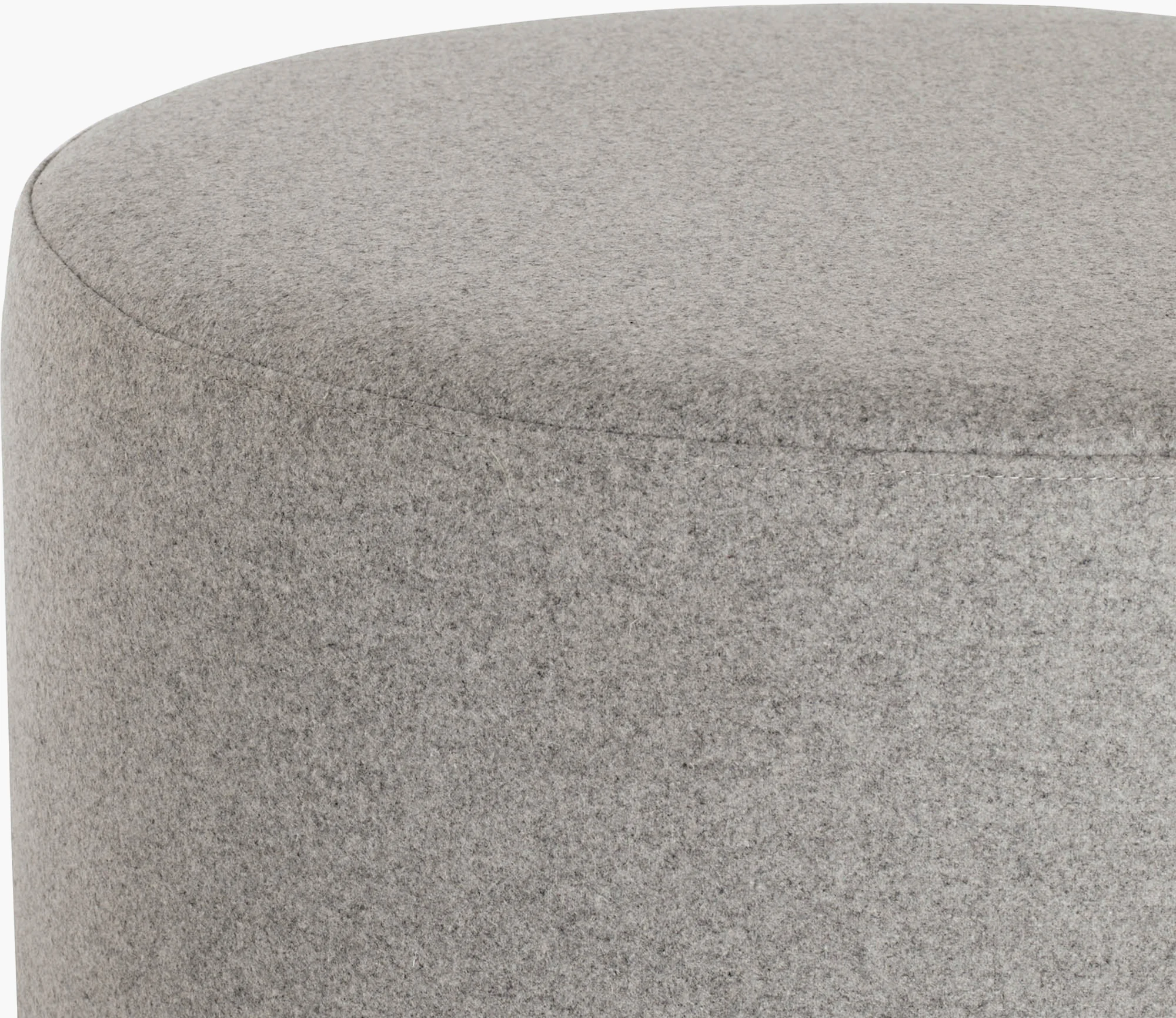 Grey upholstered wide drum pouf with textured fabric and stitched seam details