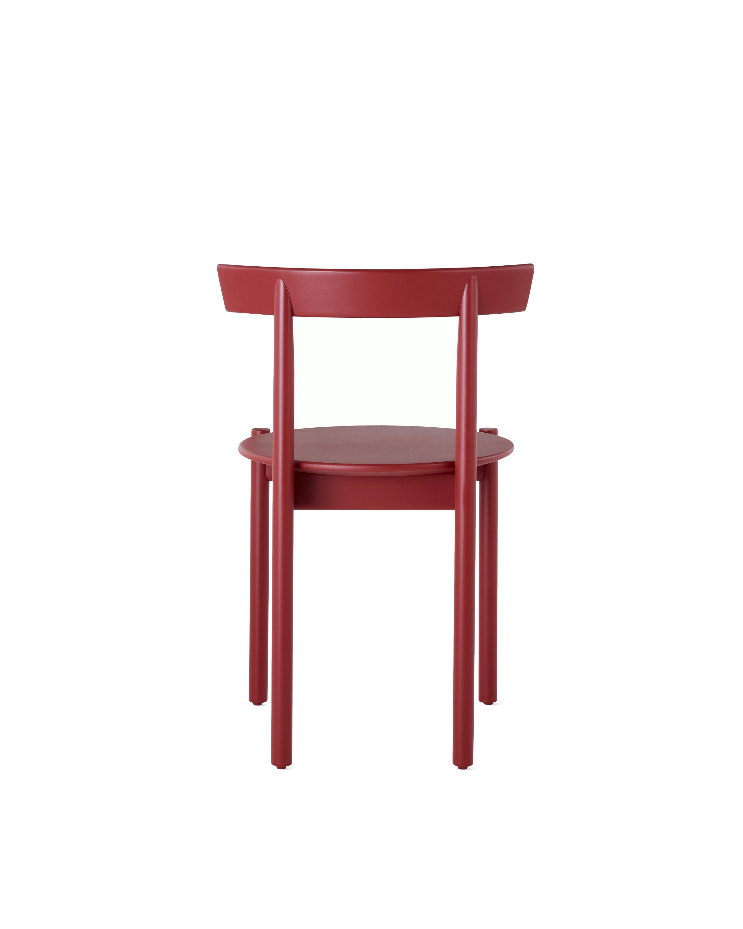 A red Comma Chair, viewed from the back.