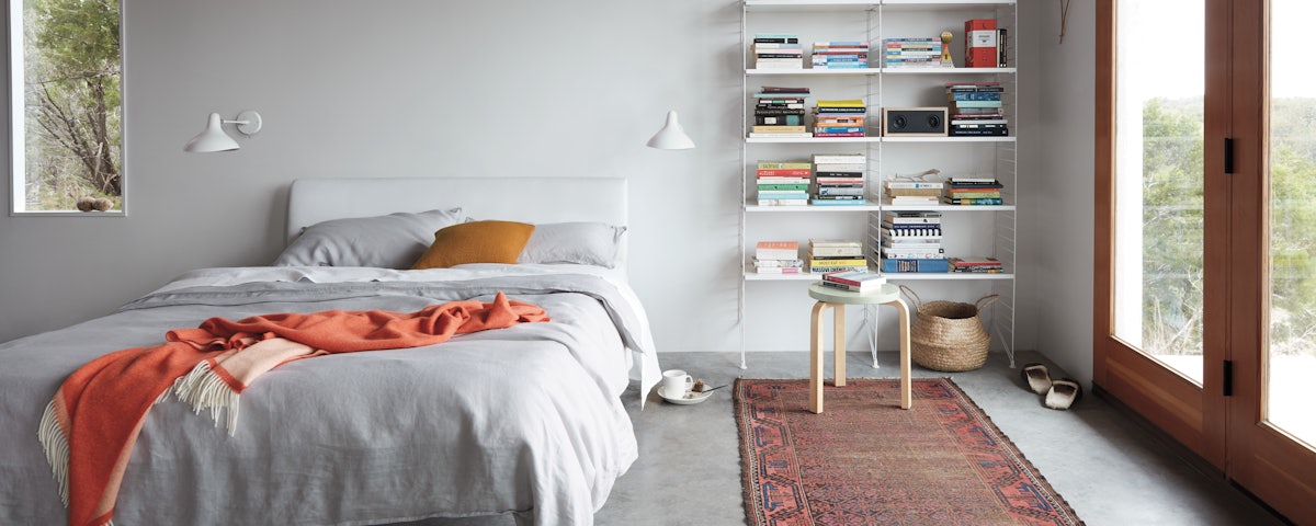 String Floor Shelving holding books in a bedroom setting