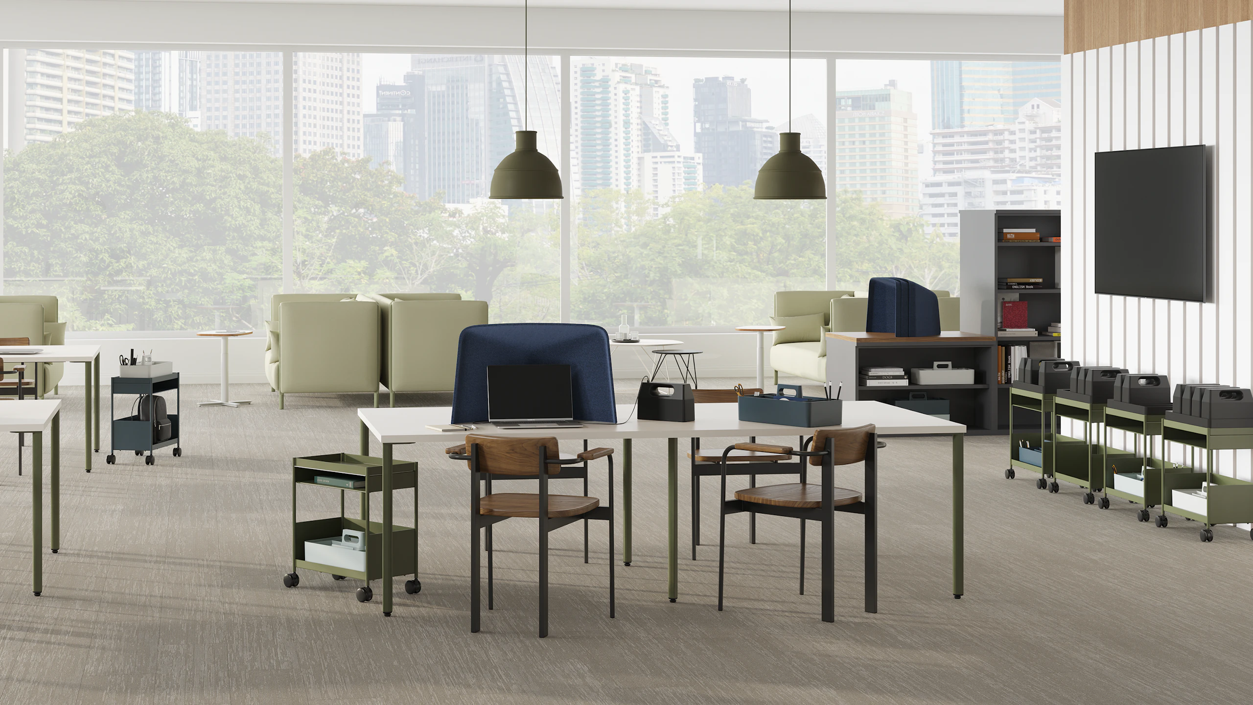 Open floor collaborative and focus space with project tables, mobile storage, privacy hoods and lounge seating.