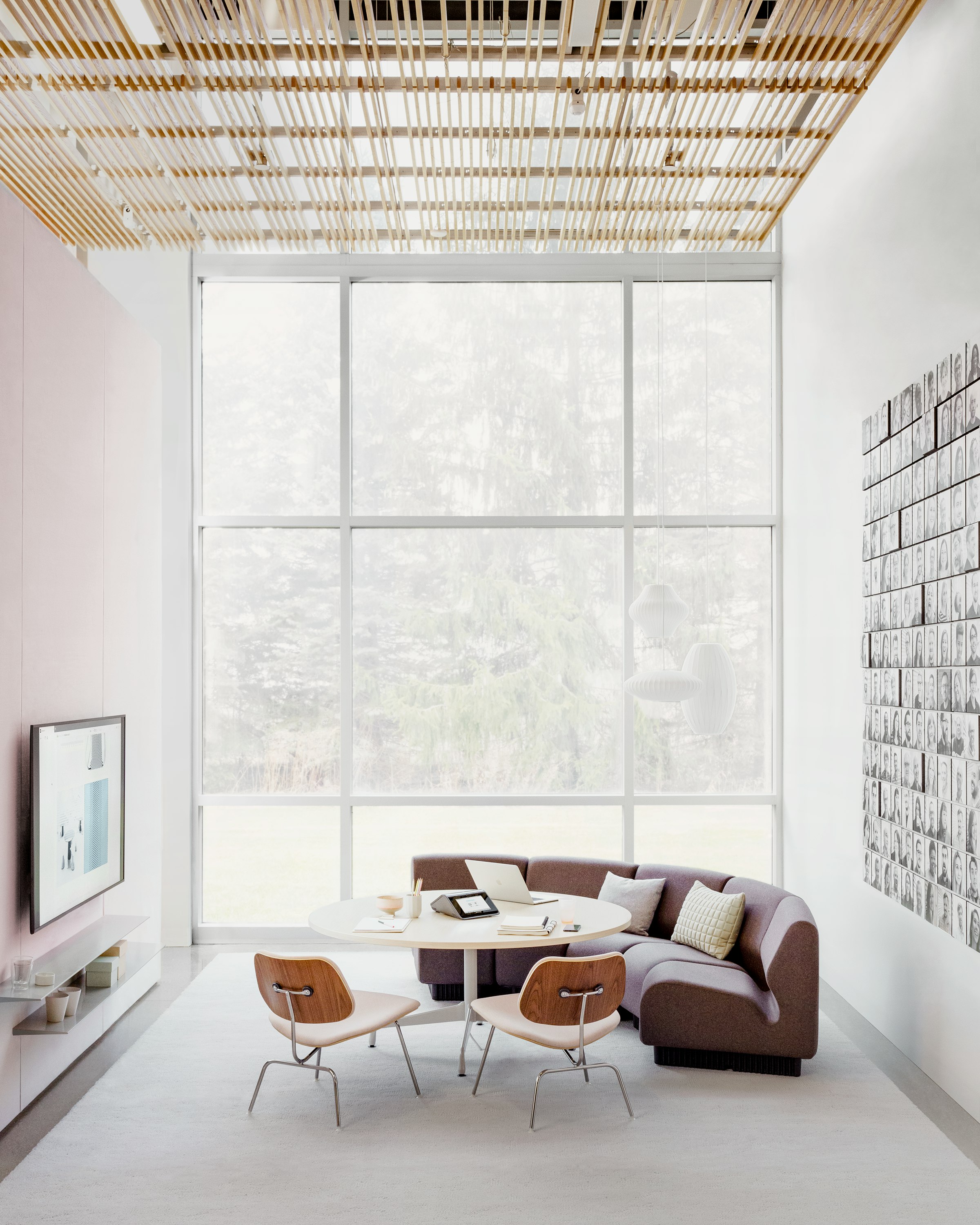 Meeting Space with curved upright lounge seating and technology integrated for screen sharing.