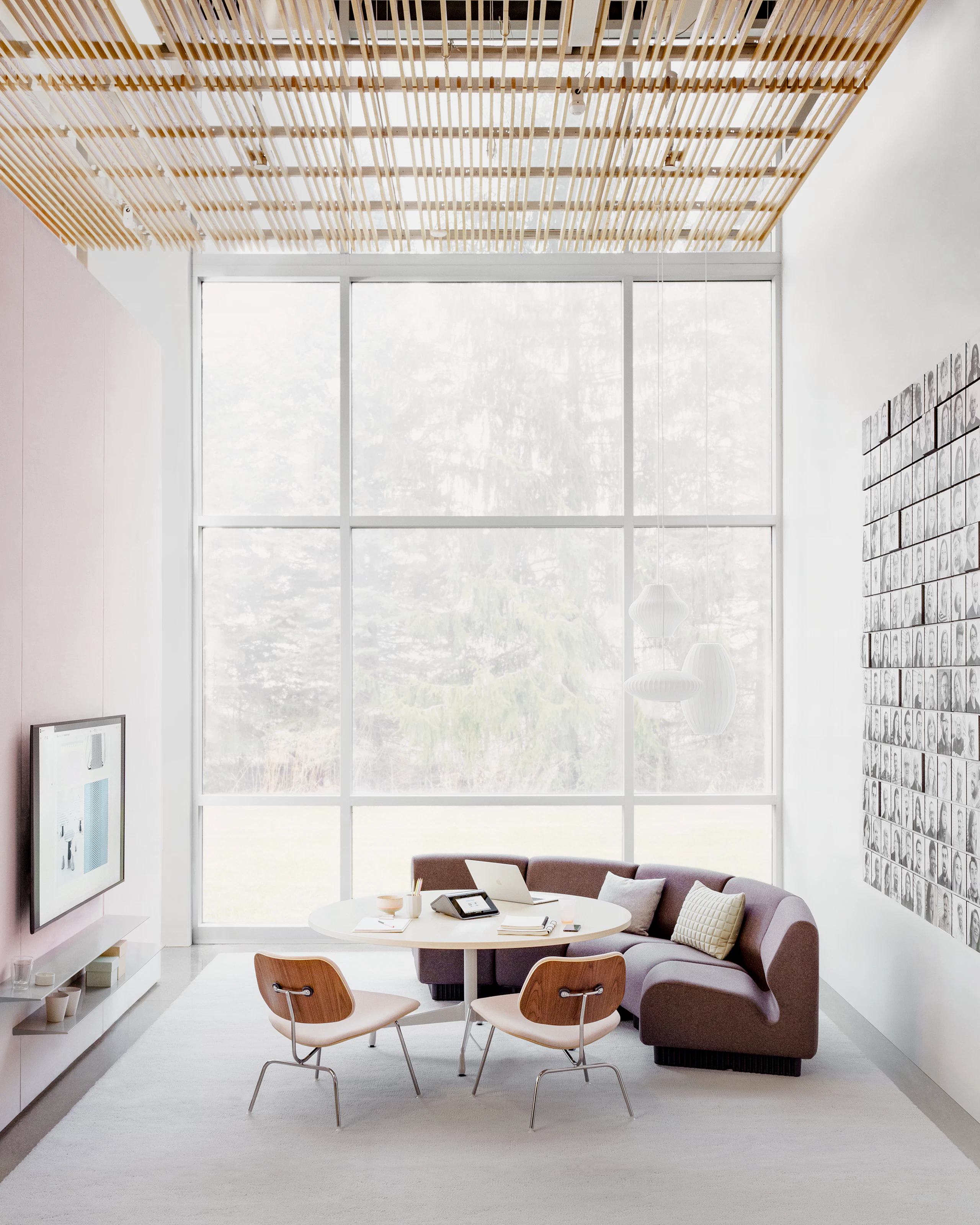 Meeting Space with curved upright lounge seating and technology integrated for screen sharing.