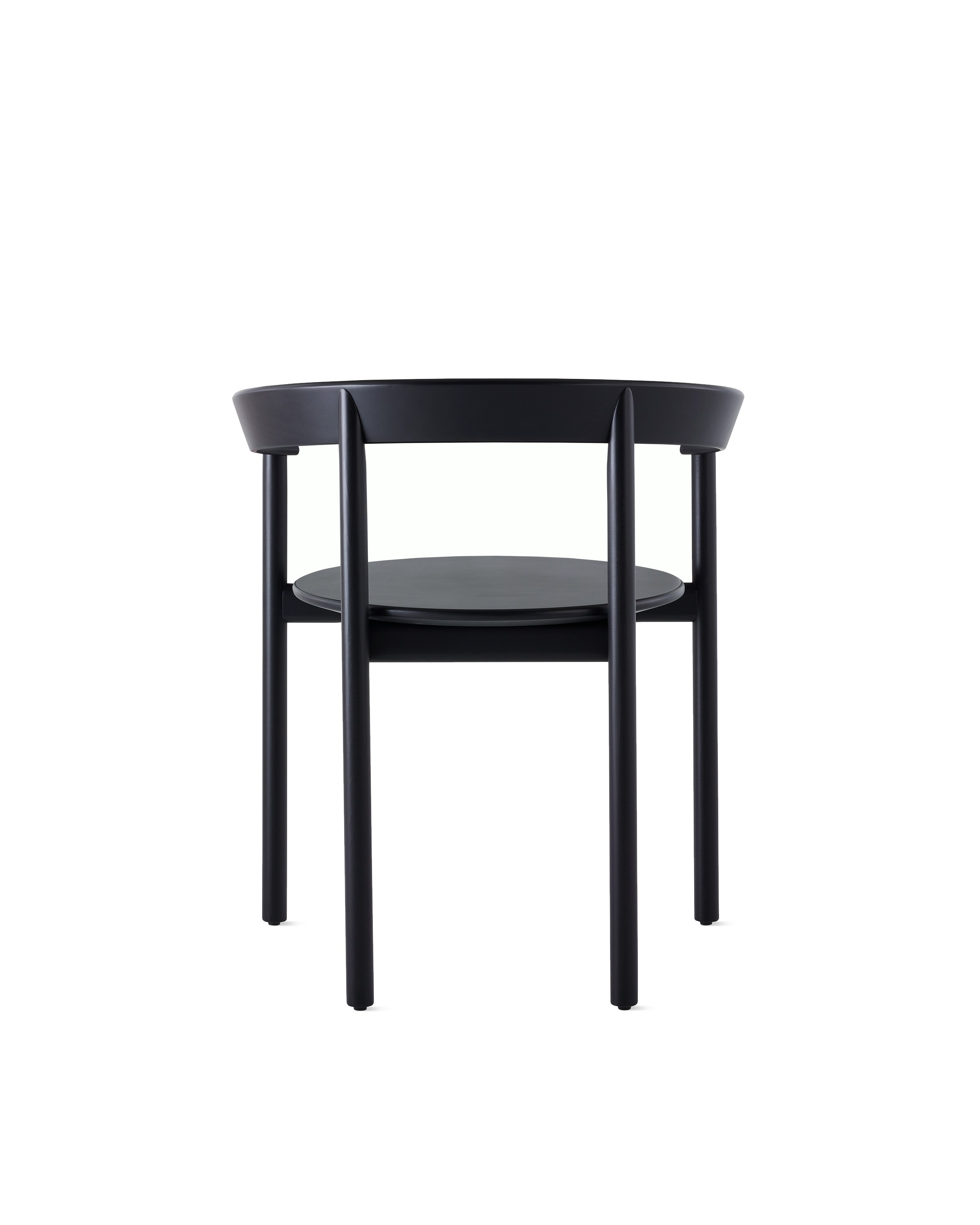 A black Comma Chair with arms, viewed from the back.