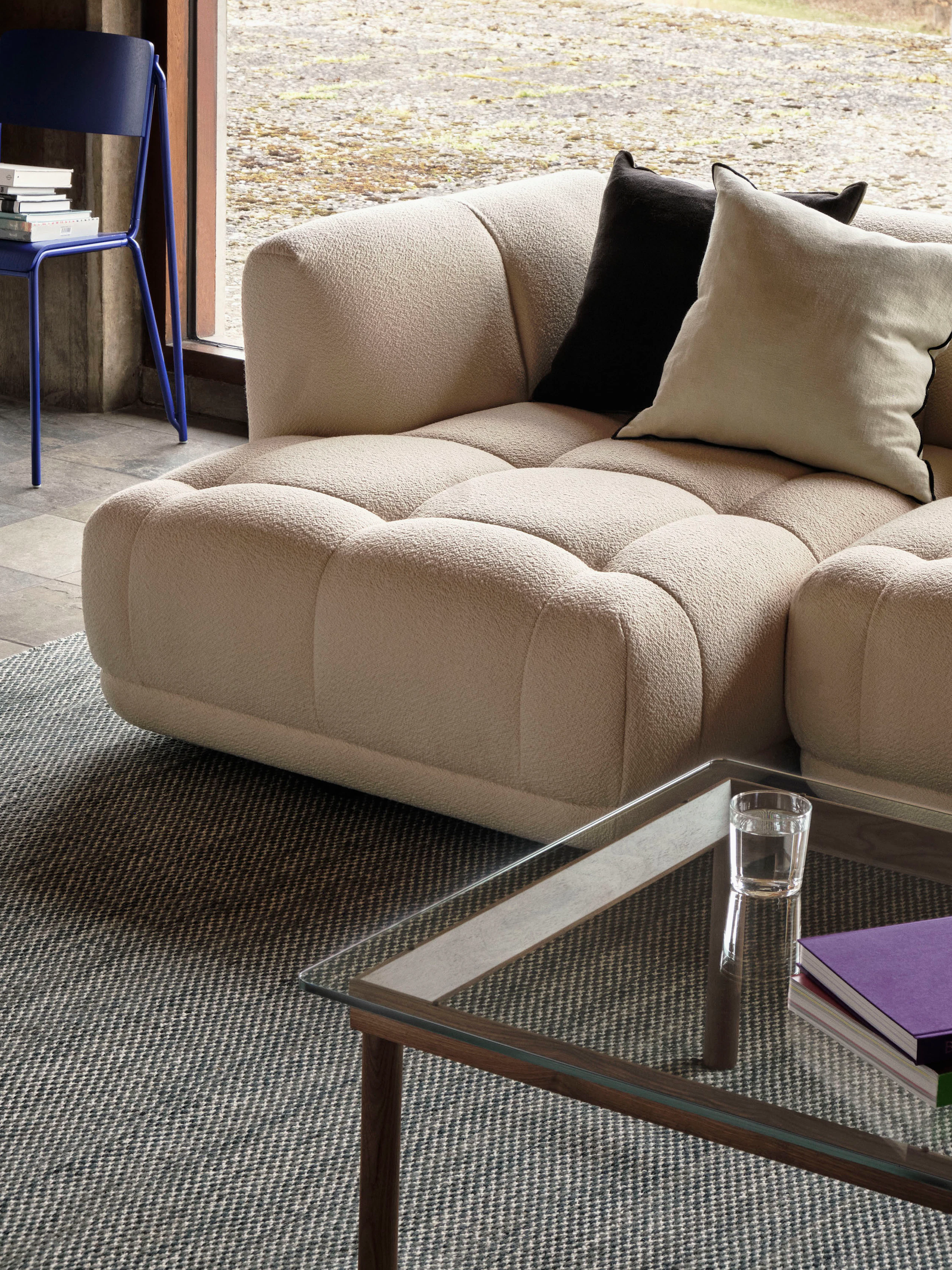A Kofi Coffee Table positioned next to a Quilton Sectional Sofa.