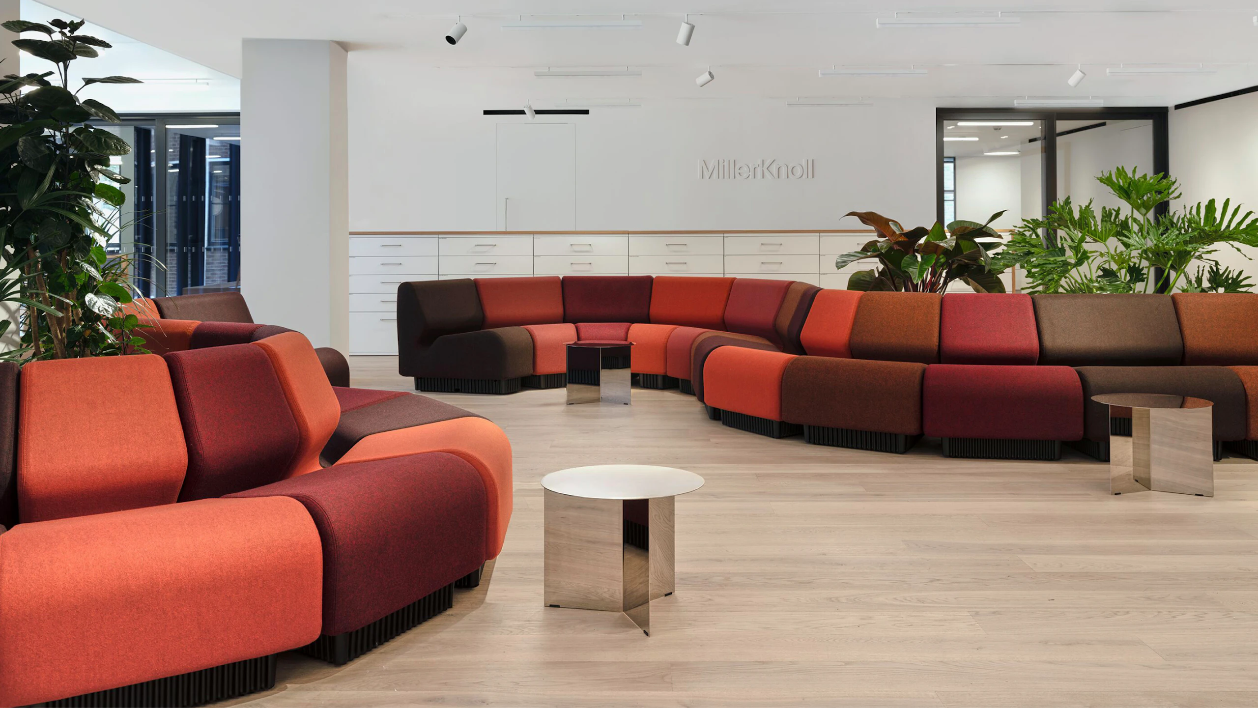 Red sectional sofas on display in the MillerKnoll London showroom at The Sans