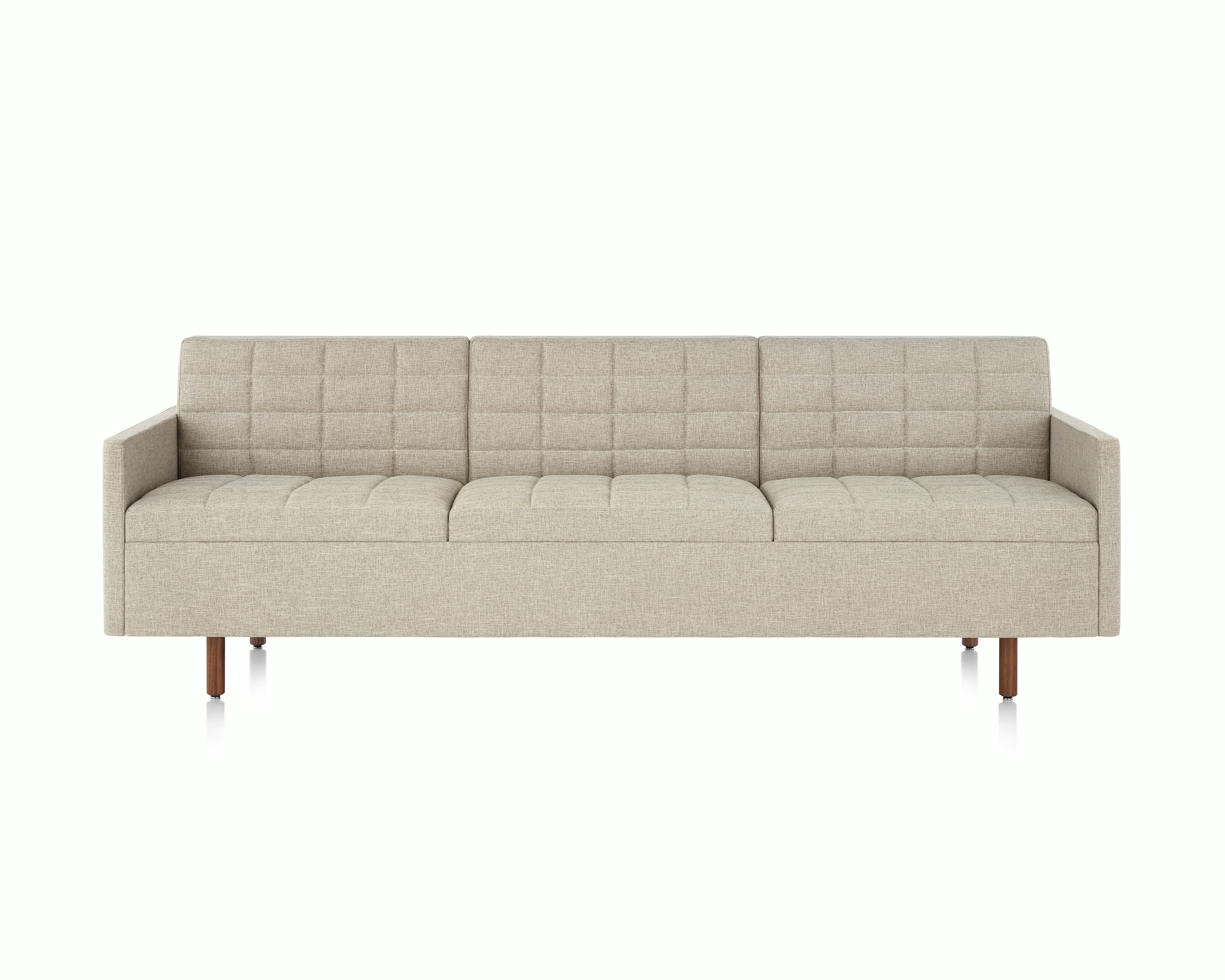 A Tuxedo Classic sofa with bone-colored quilted upholstery, viewed from the front.