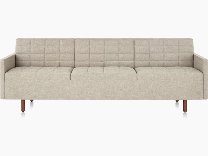 A Tuxedo Classic sofa with bone-colored quilted upholstery, viewed from the front.