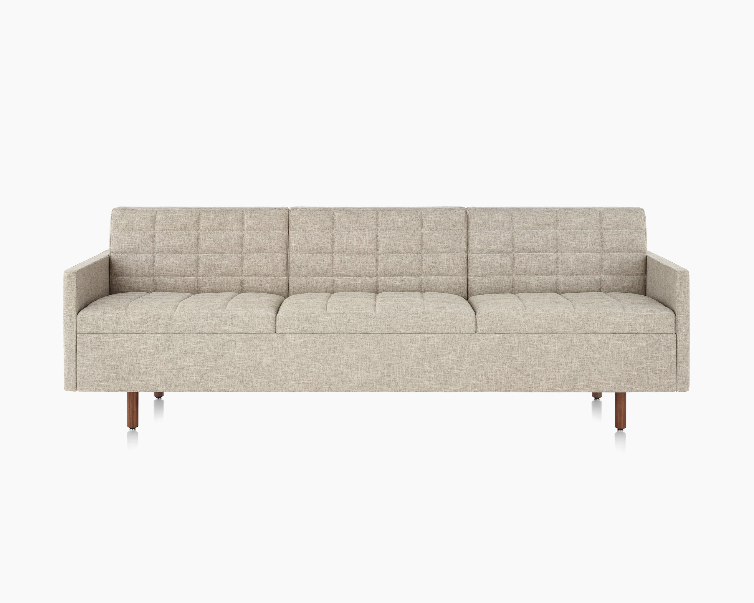 A Tuxedo Classic sofa with bone-colored quilted upholstery, viewed from the front.