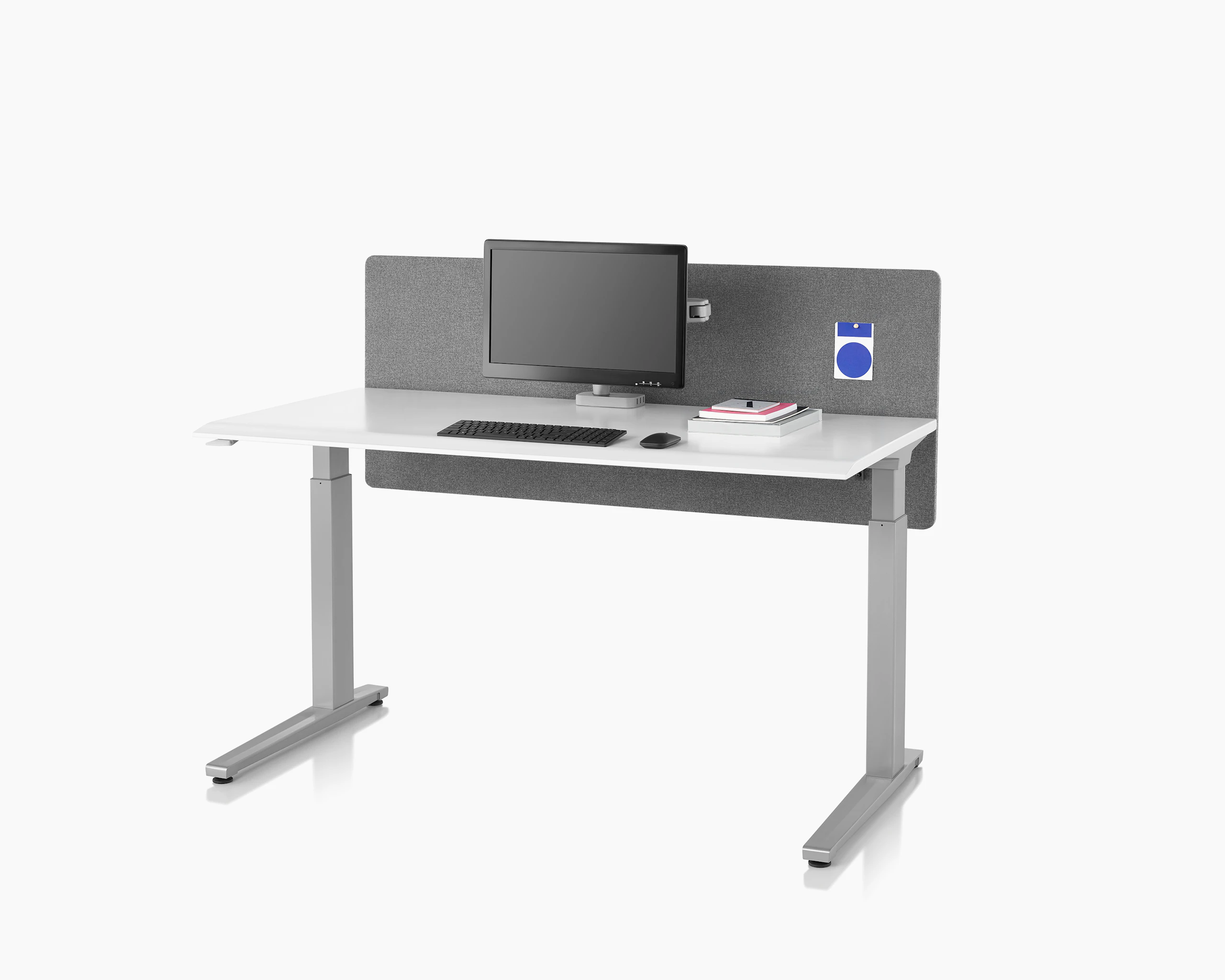 A gray fabric flat edge privacy screen installed on a Renew Sit-to-Stand Table that has a white top and silver legs.