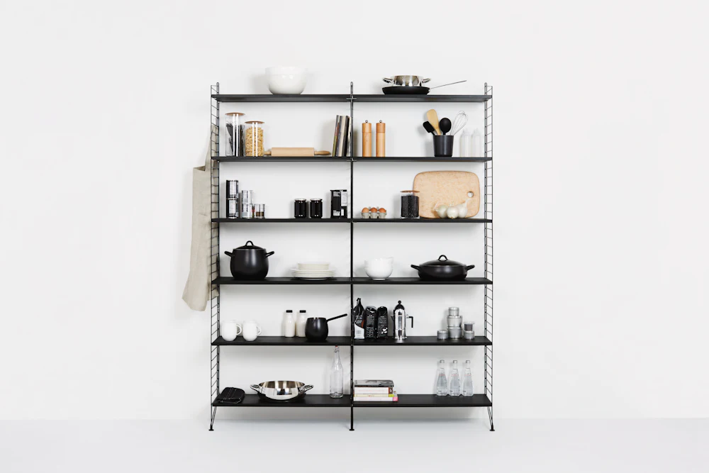 Open metal-framed shelving unit with dishware styling