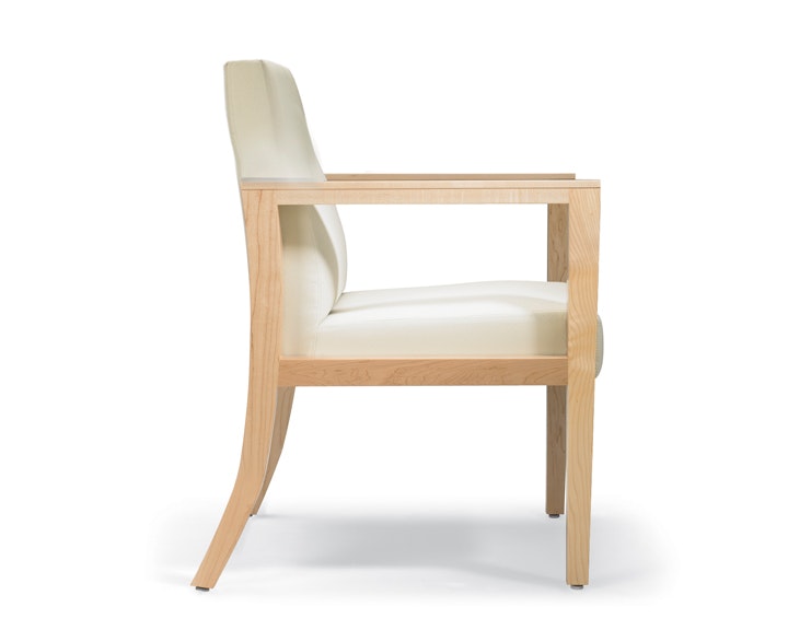 A side view of a Brava 863 Chair with maple frame and white textile.