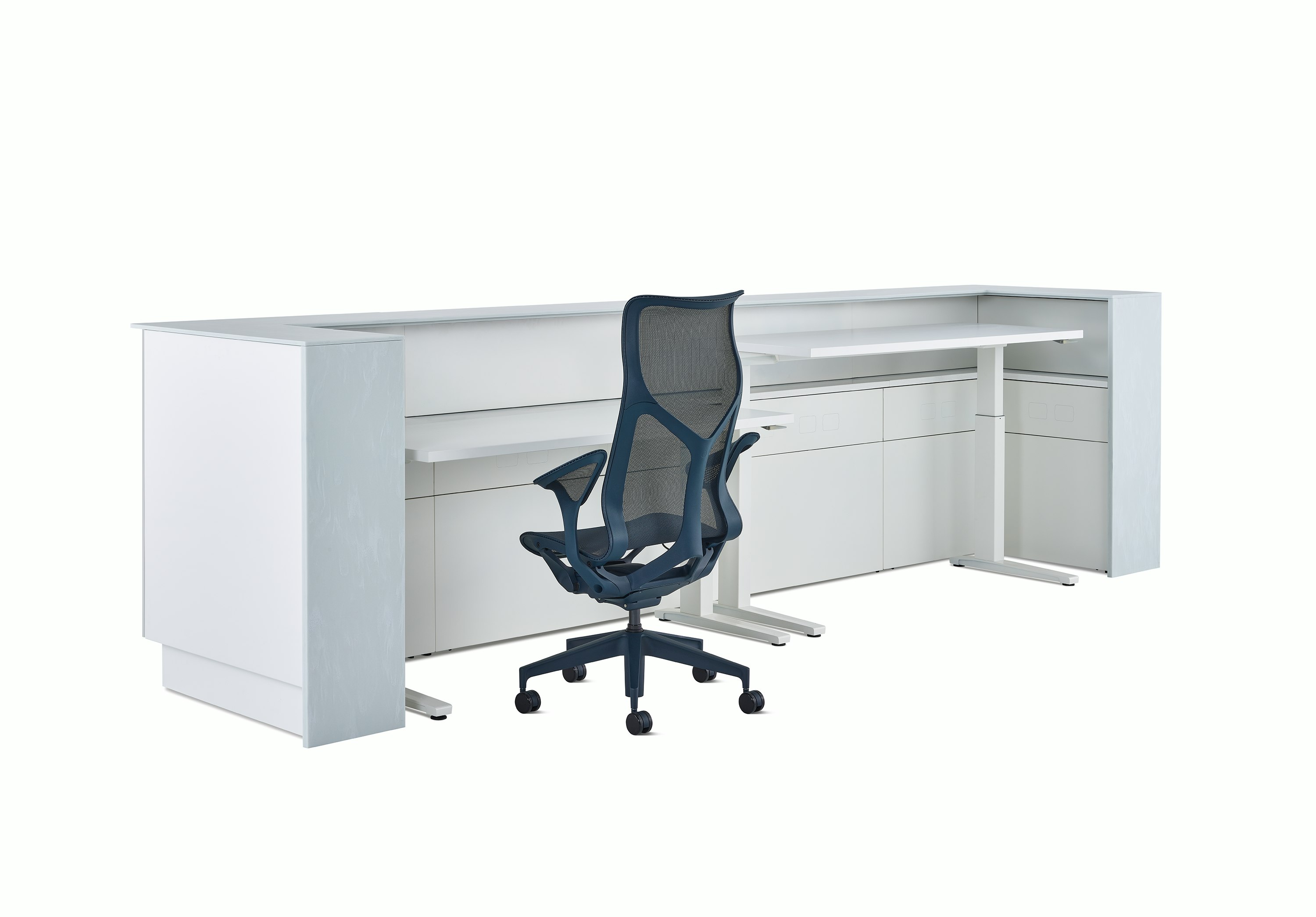 A Commend Nurses Station with two white Renew Sit-to-Stand Tables at differing heights and a Cosm chair tucked within its interior.