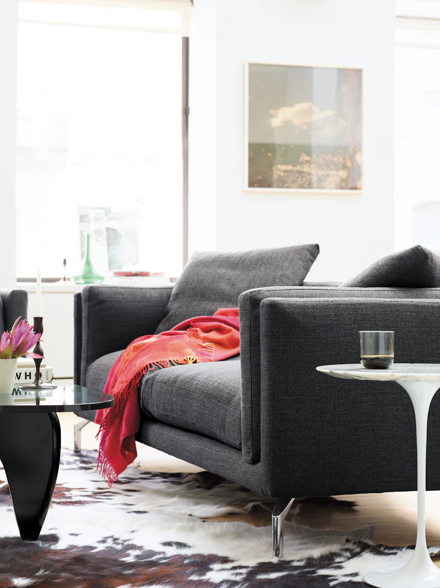 Close view of gray sofa with red throw blanket