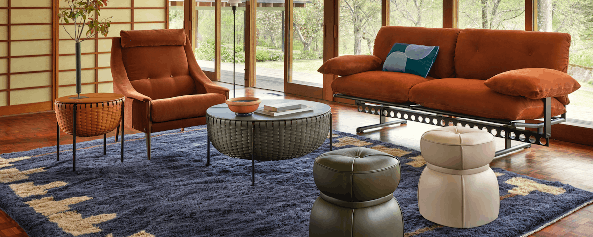 Backgammon Wool Moroccan Rug under an Ouverture Sofa, Lepli Ottomans and Cestlavie Table in a living room setting