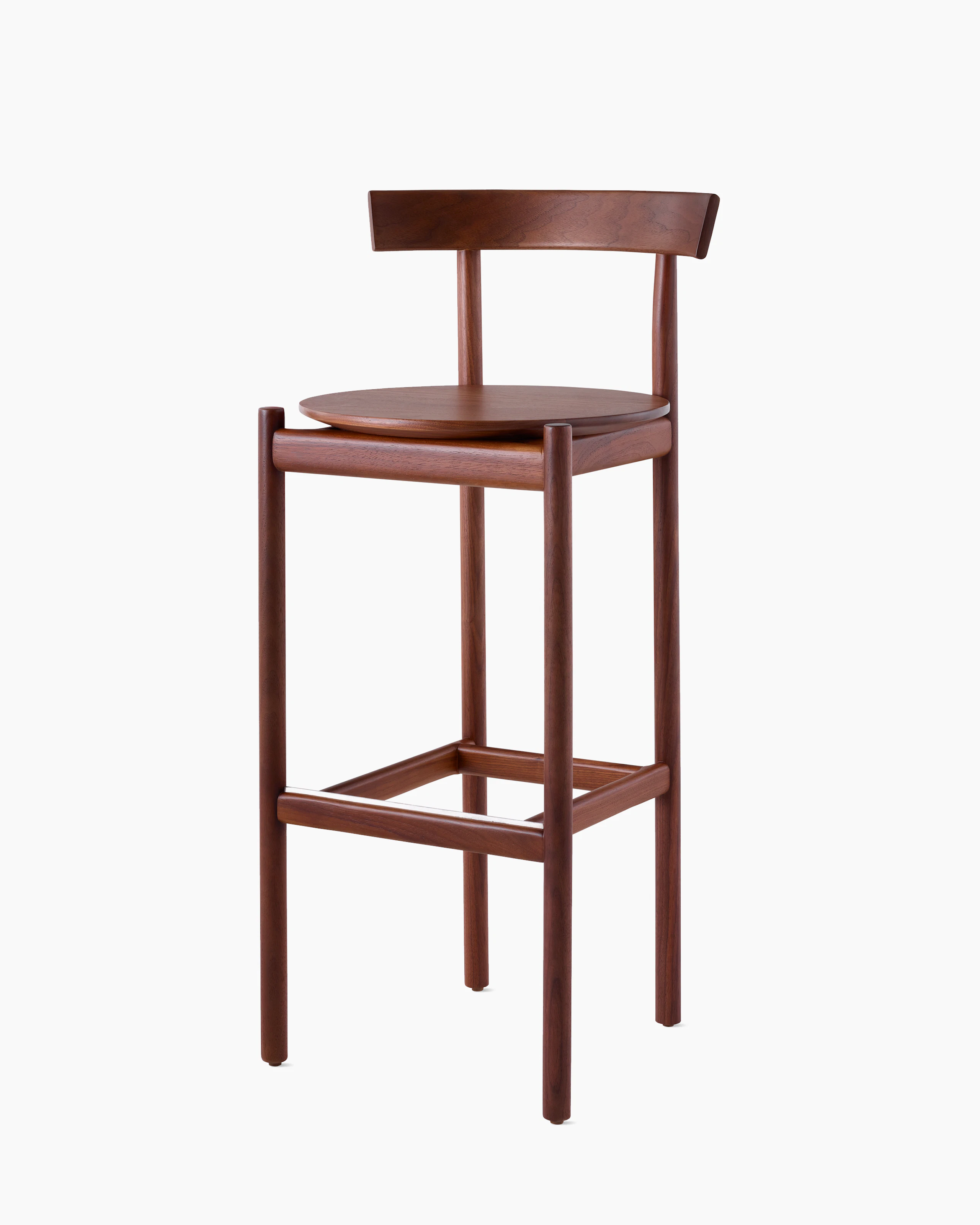 A walnut bar-height Comma Stool, viewed from the front at an angle.