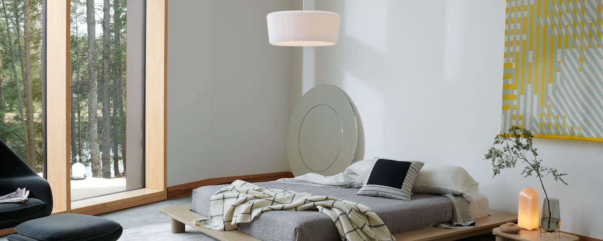 Plie Plisse Light over bed in bedroom setting