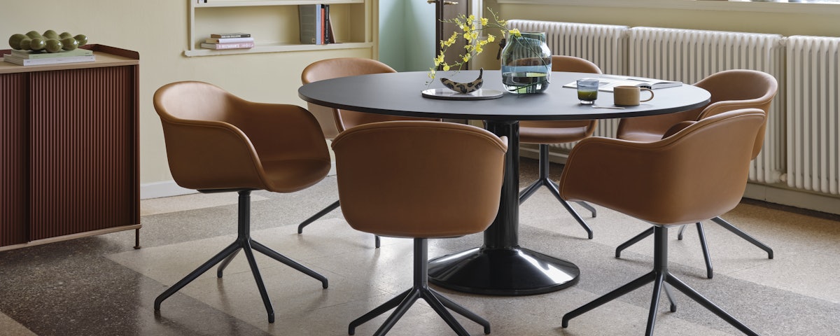 Midst Table in Black Linoleum / Black surrounded by chairs in a dining room setting