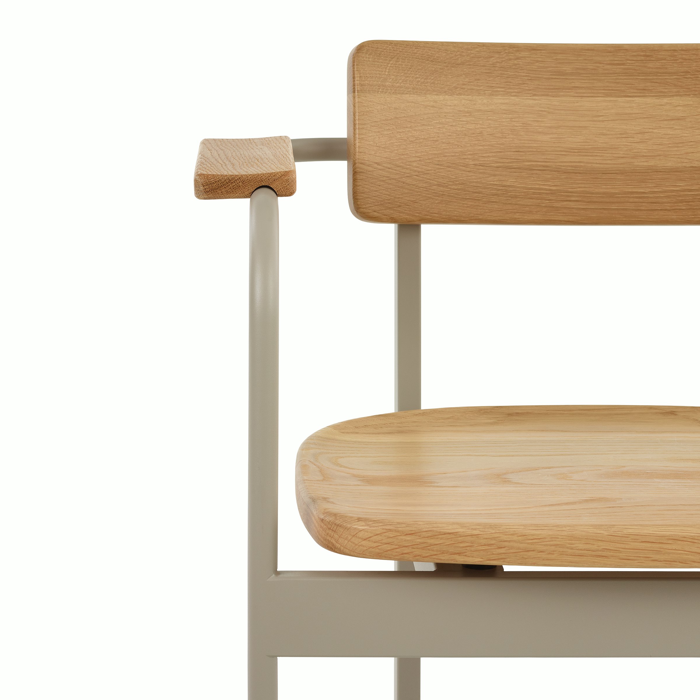 A close-up of the front of a Betwixt Chair with oak seat and backrest with a grey frame.