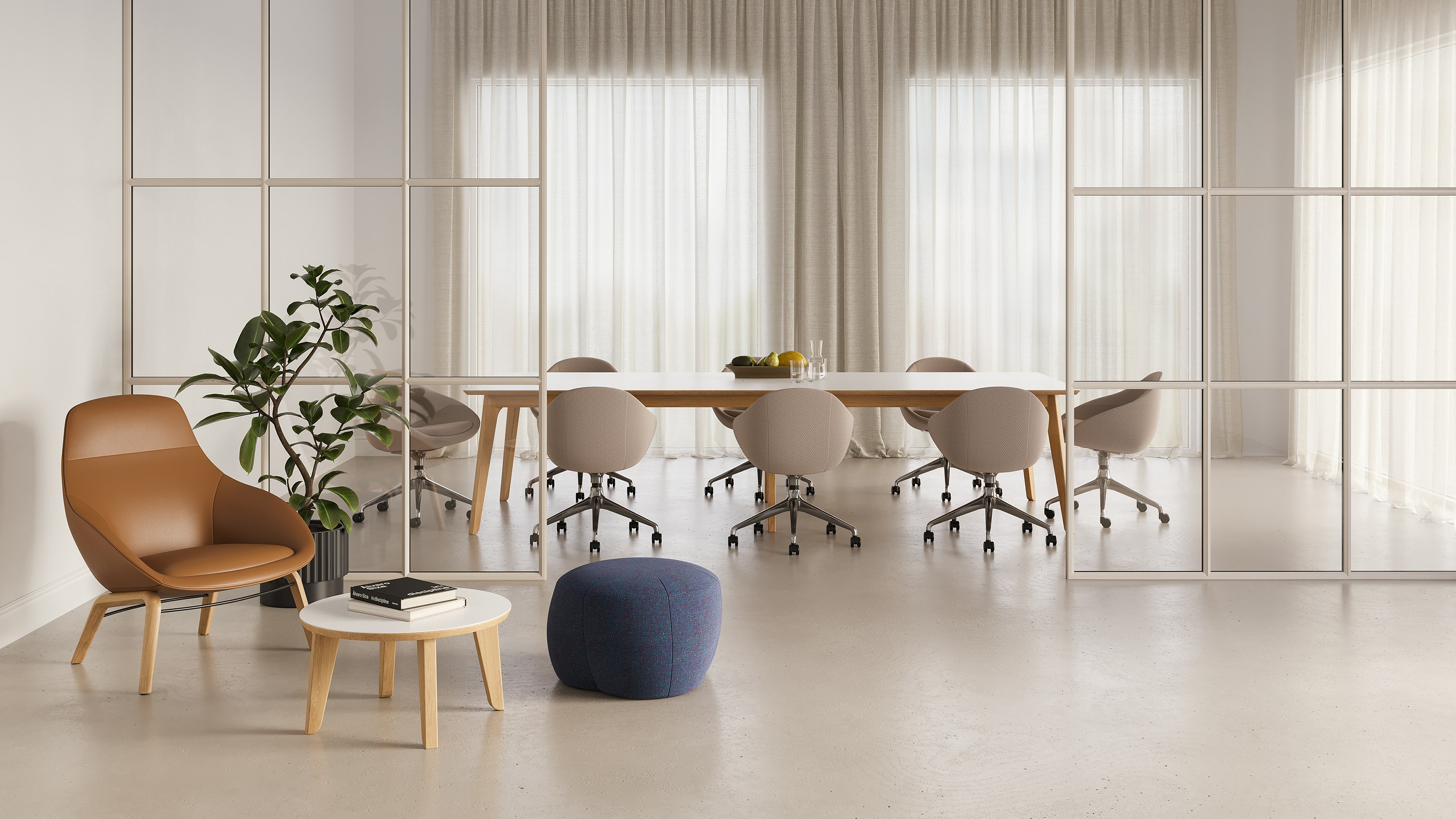 A lounge setting outside a meeting room showing a low Truffle Pouf and Always Lounge Chair on either side of a Dalby Coffee Table.