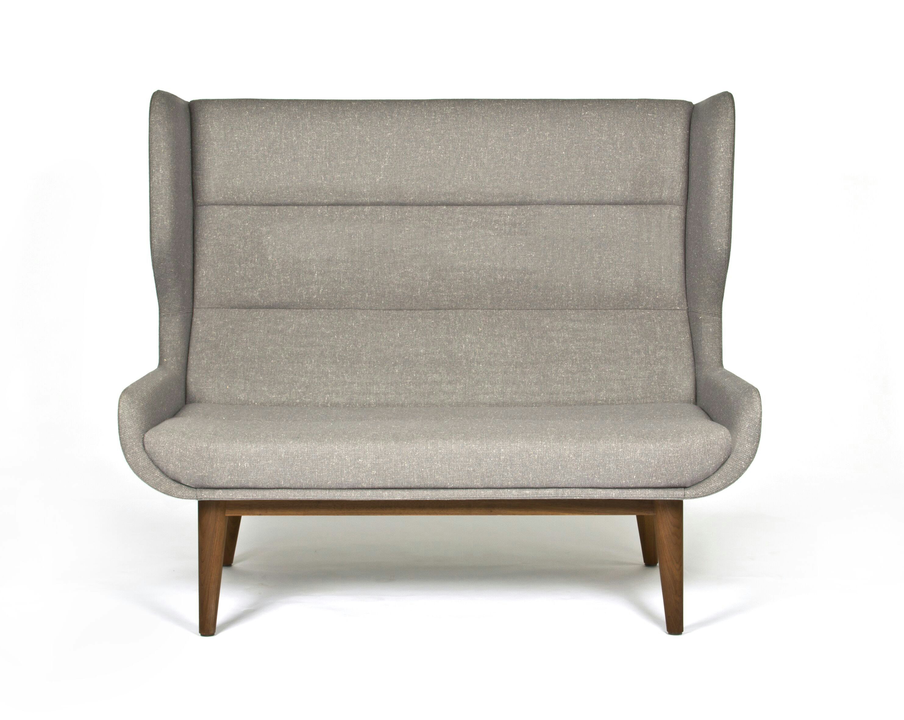 A gray, high-backed Hush Sofa with a walnut base, viewed from the front.