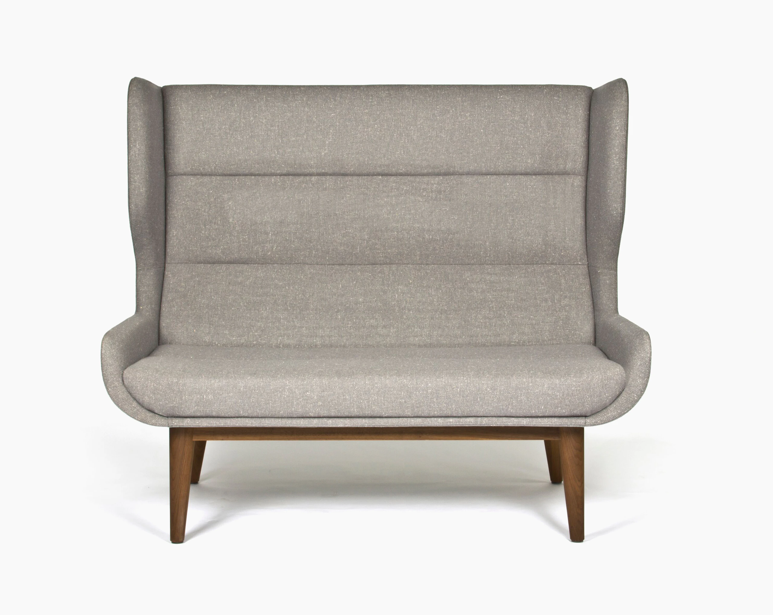 A gray, high-backed Hush Sofa with a walnut base, viewed from the front.