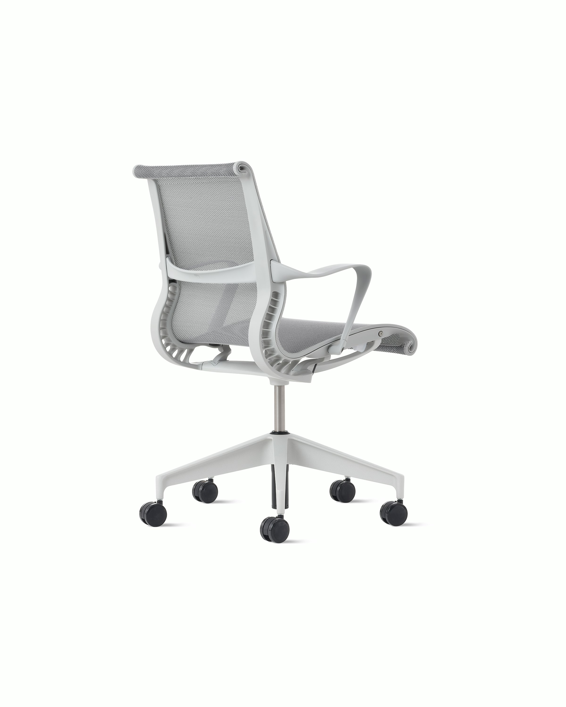 Rear angle view of a Setu chair in light grey.