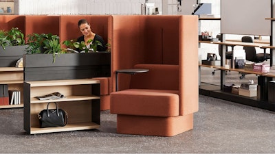 A bank of burnt-orange NaughtOne Pullman chairs next to Herman Miller OE1 Storage Trolleys in an individual study hall setting designed to cultivate an area of focus and wellbeing