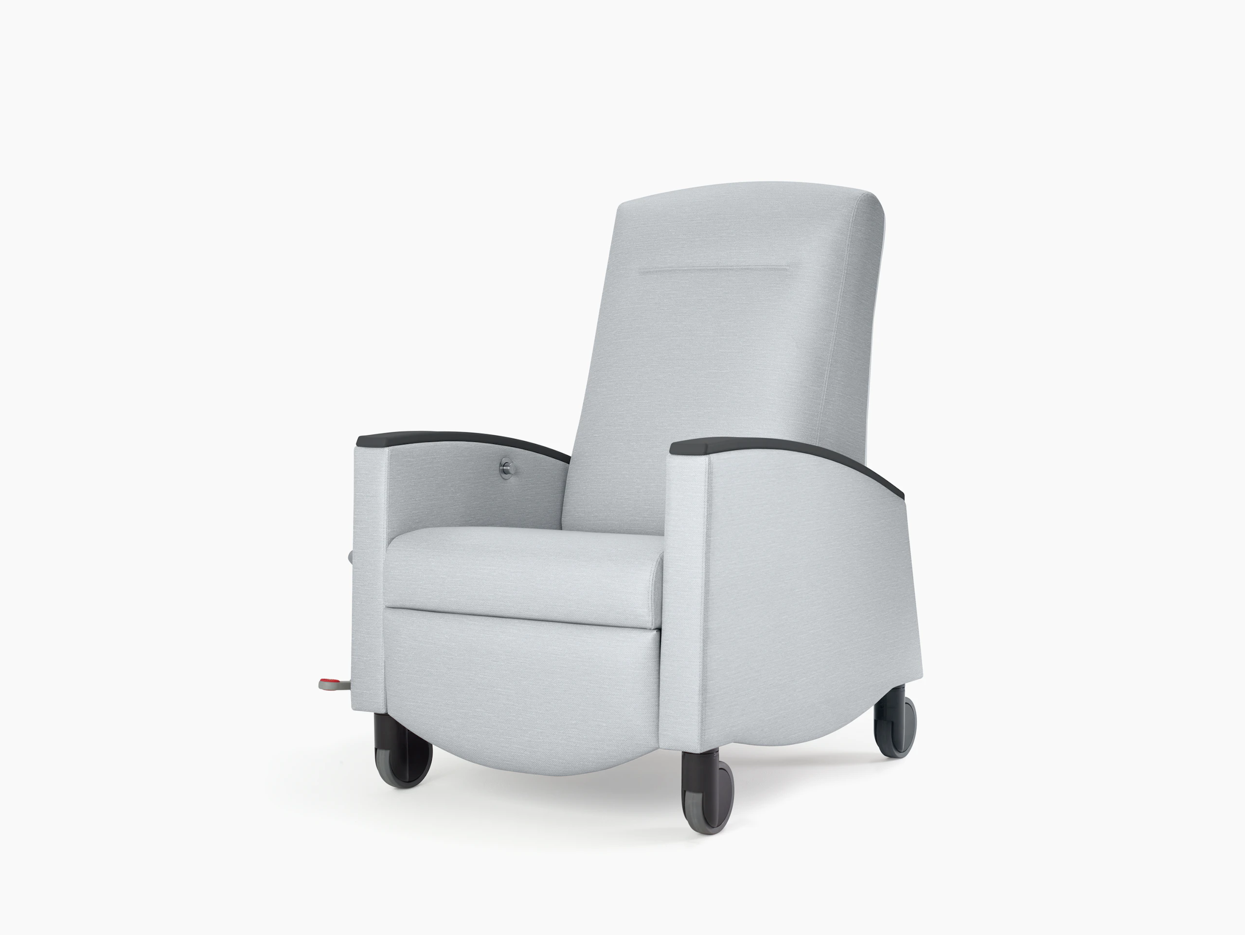 Nemschoff Sahara Recliner in a light gray upholstery with black arm caps and casters on white sweep, viewed at an angle.