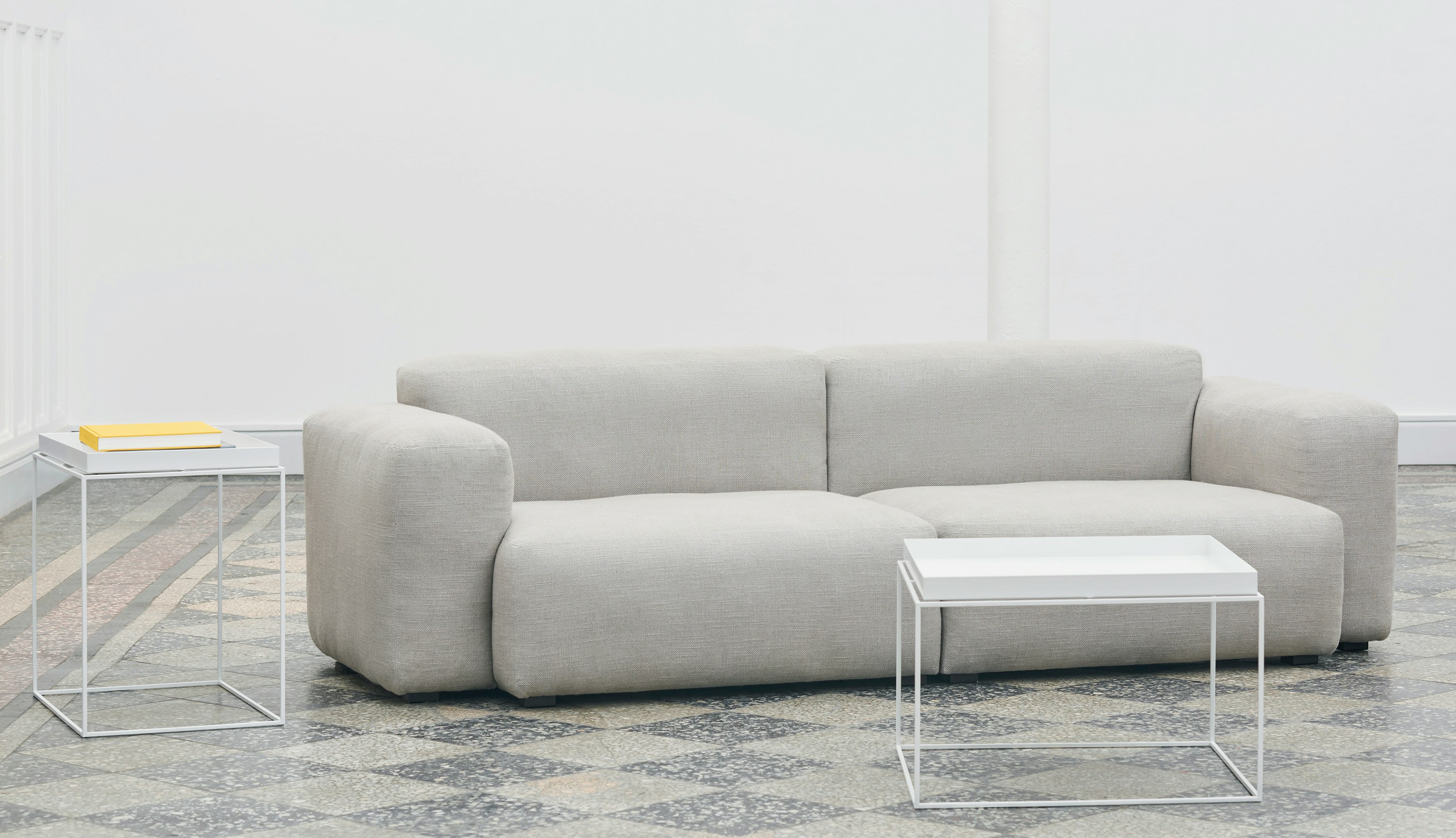 White Tray Coffee Table and Tray Side Table staged with a grey Mags Soft Sectional Sofa.