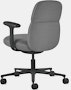 Rear angle view of a mid-back Asari chair by Herman Miller in dark grey with height adjustable arms.