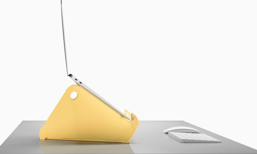Side profile of an open and raised laptop on an Oripura Laptop Stand in yellow.