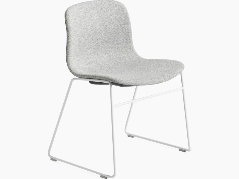 About A Chair grey upholstered seat shell on white wireframe sled base, front angled view.