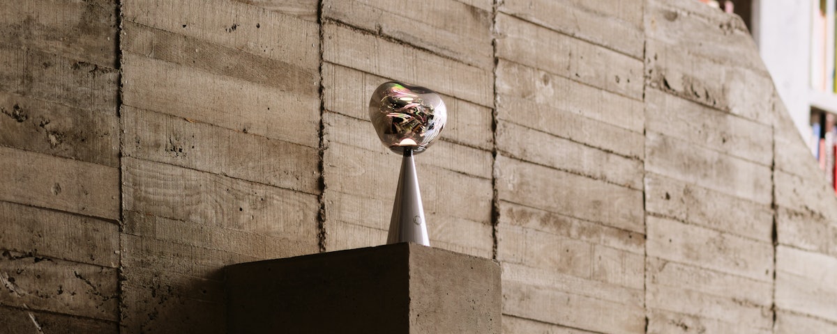 Melt Portable Table Lamp in front of a concrete wall