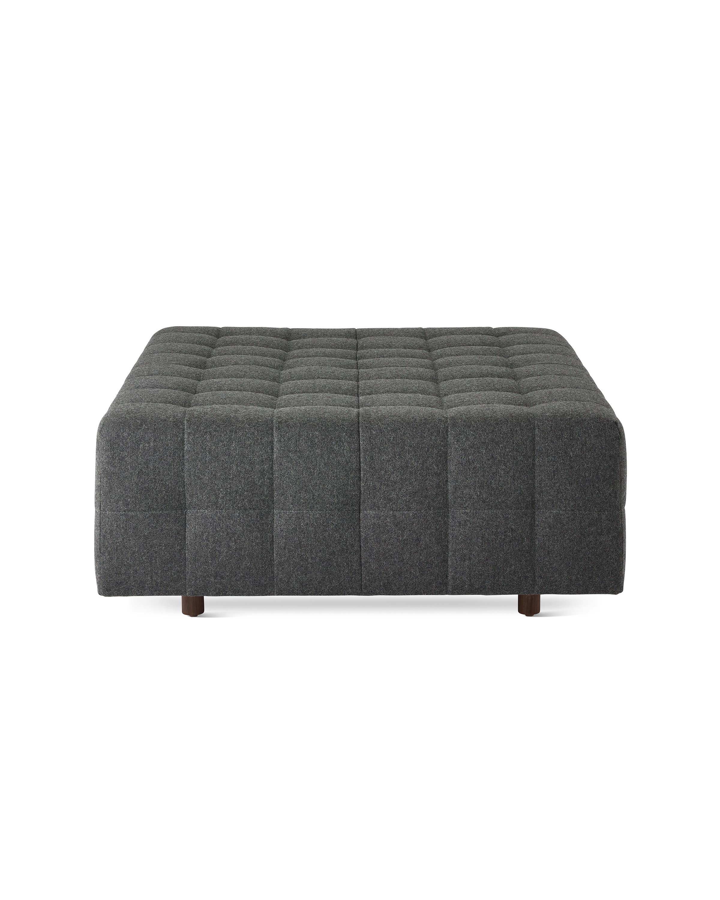 A Rapport ottoman upholstered in a dark grey fabric.