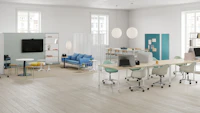 Open floor office space with task chairs, project tables, height-adjustable tables, soft seating and movable walls.