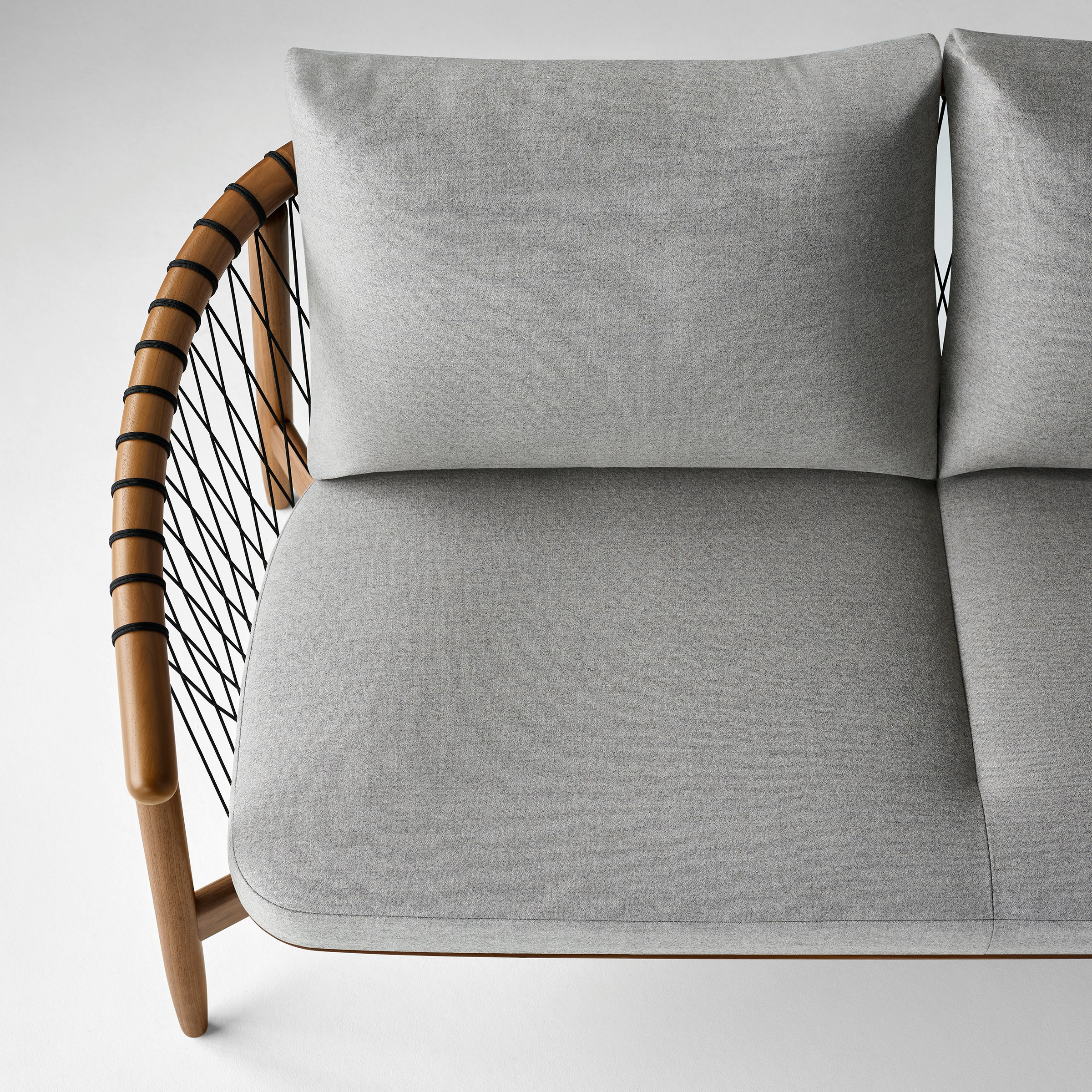 An aerial view of a Crosshatch Settee with a walnut frame, black cords, and a light neutral fabric.