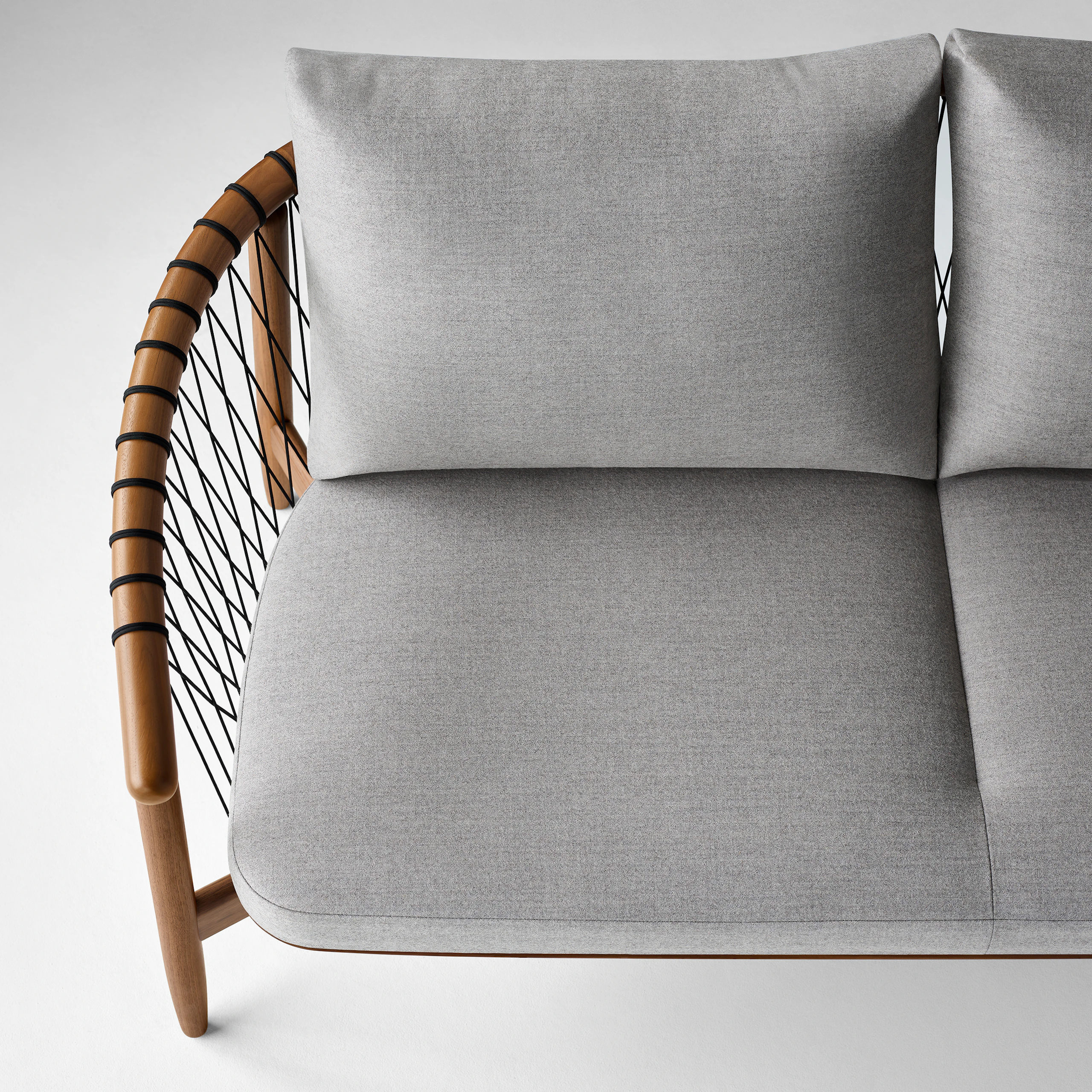 An aerial view of a Crosshatch Settee with a walnut frame, black cords, and a light neutral fabric.