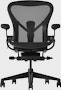 Black matte Aeron Chair on a white background with a 5-star base and ergonomic back support, viewed from the front.