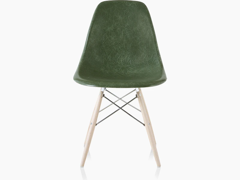 An Eames Molded Fiberglass Side Chair with a dowel base and dark green seat, viewed from the front.