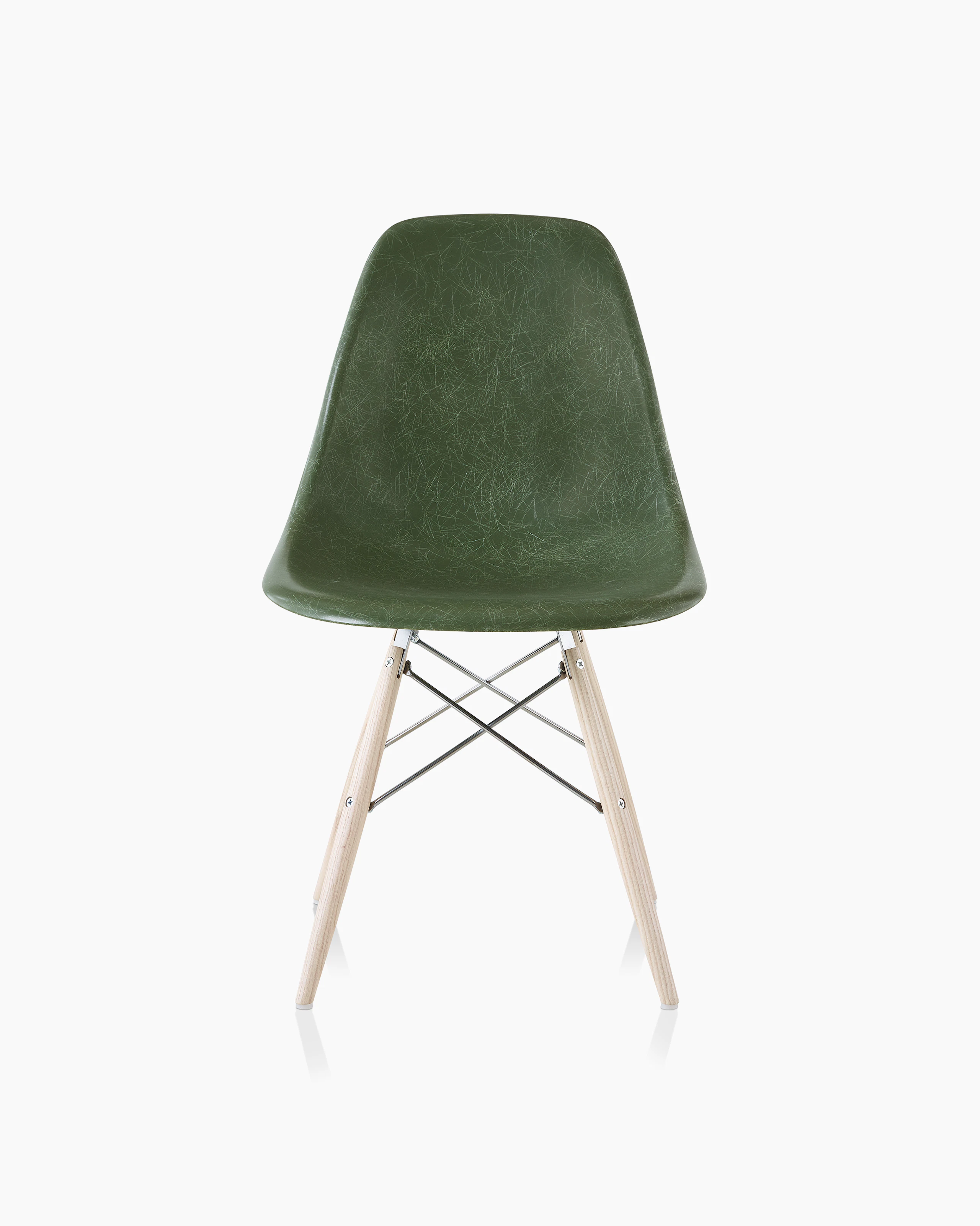 An Eames Molded Fiberglass Side Chair with a dowel base and dark green seat, viewed from the front.