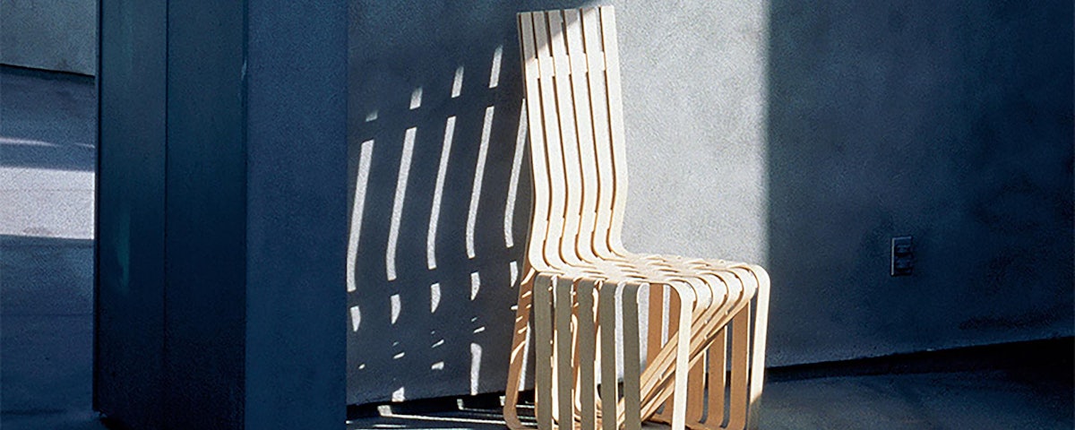 Gehry High Sticking High Back Chair in an outdoor courtyard setting