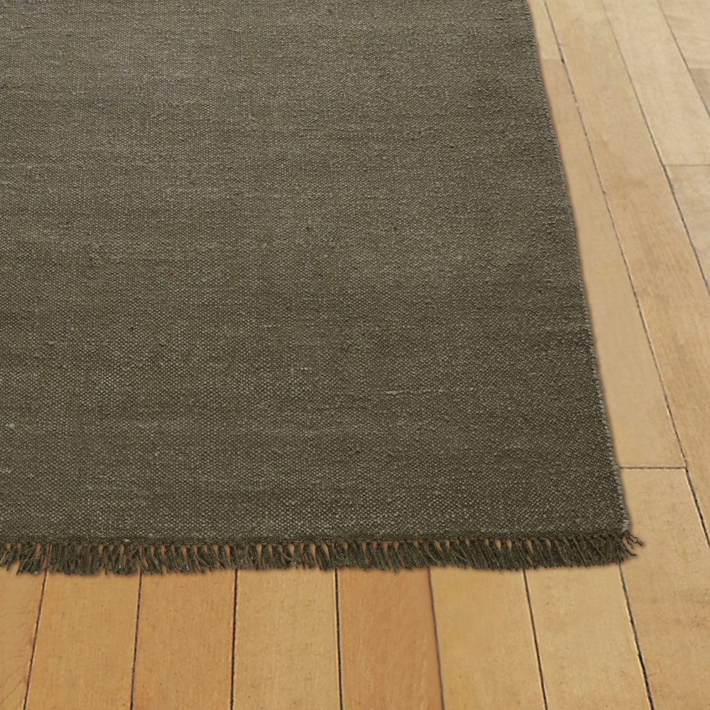 A linen rug on a hardwood floor.
