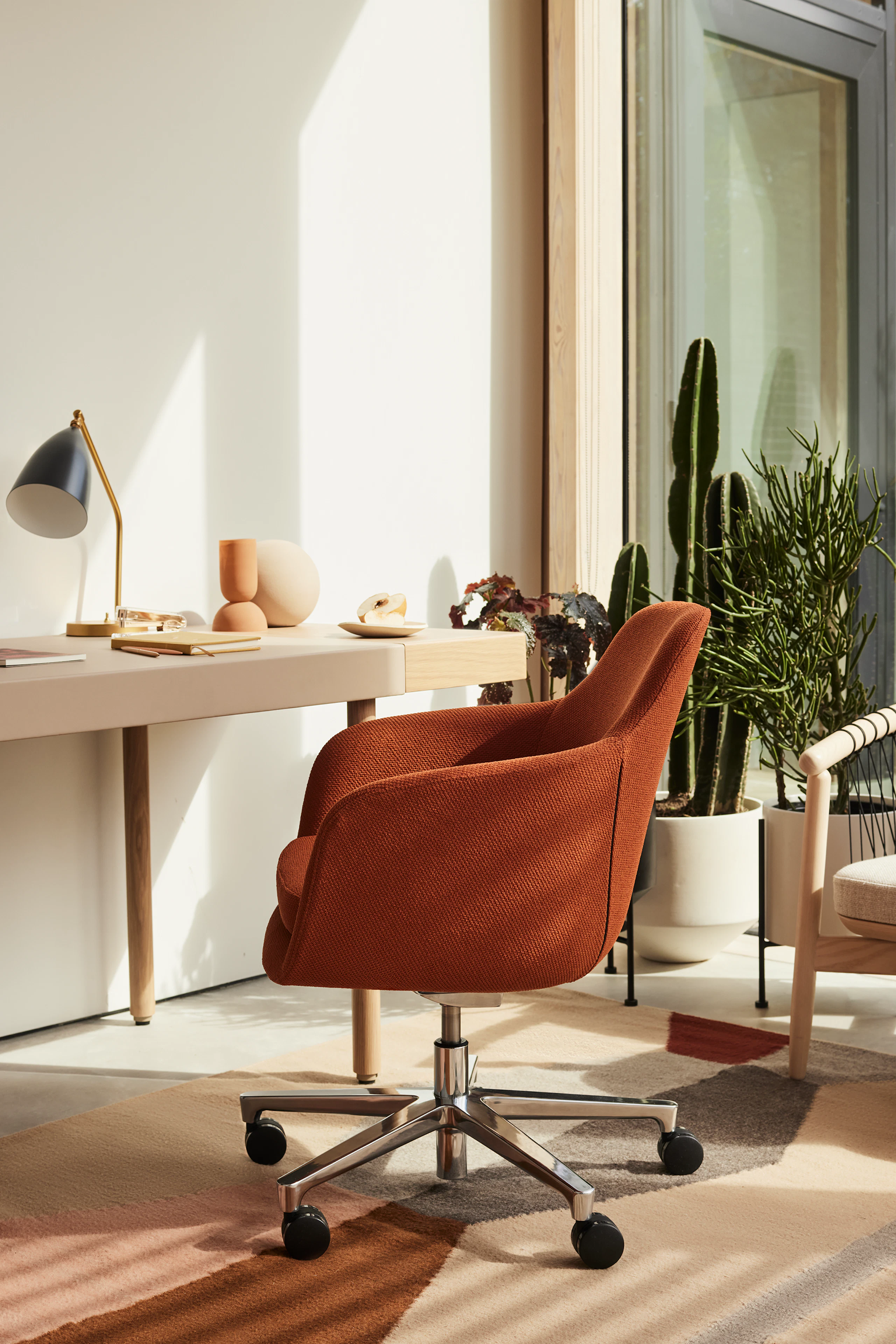 A home office setting with Saiba Chair and New Canaan Leatherwrap Sit-to-Stand Desk.