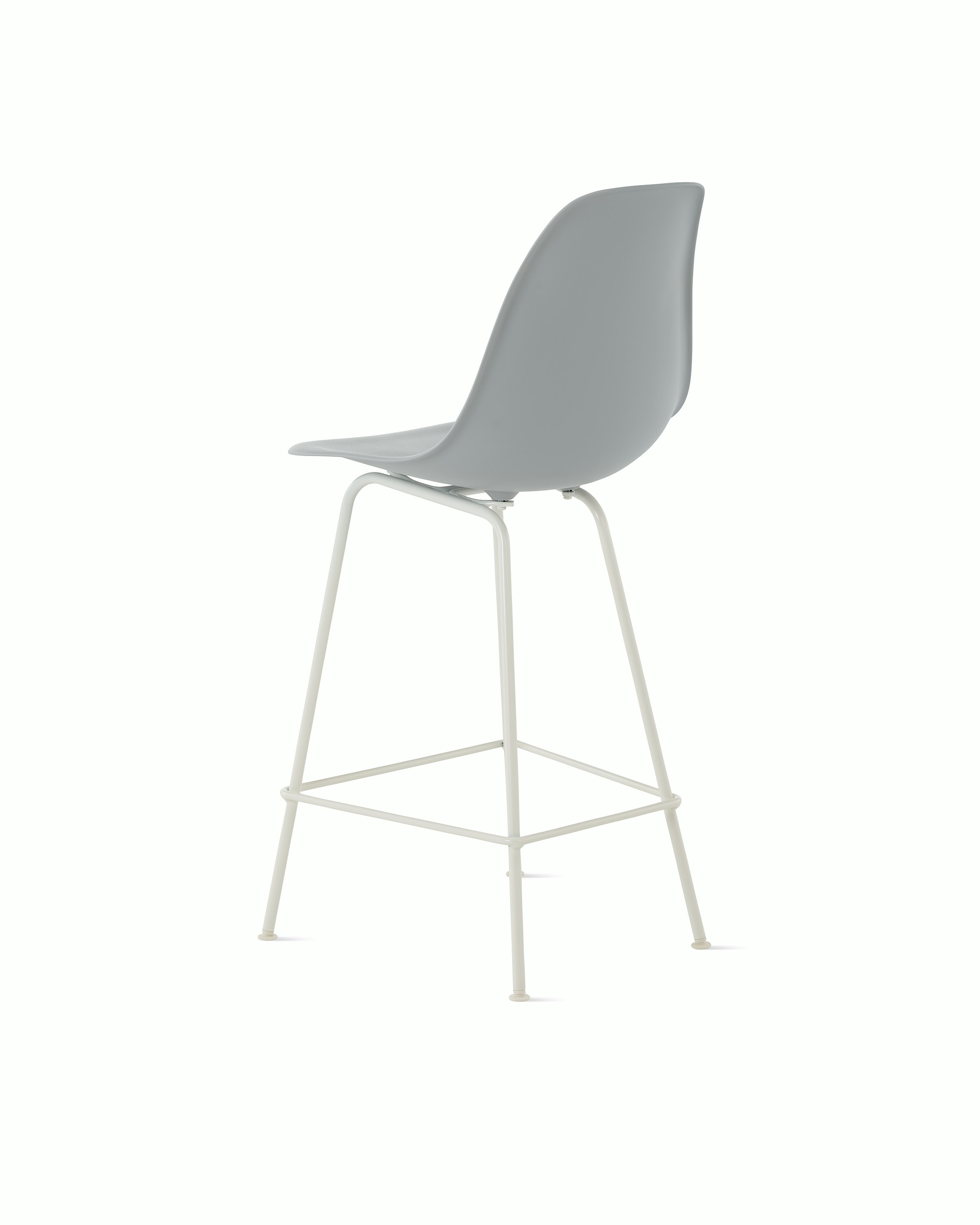 Back angle of light grey plastic shell stool on 4 leg base.