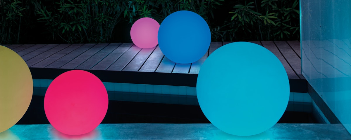 Pearl, Ball and Globe Portable Lamps at a poolside