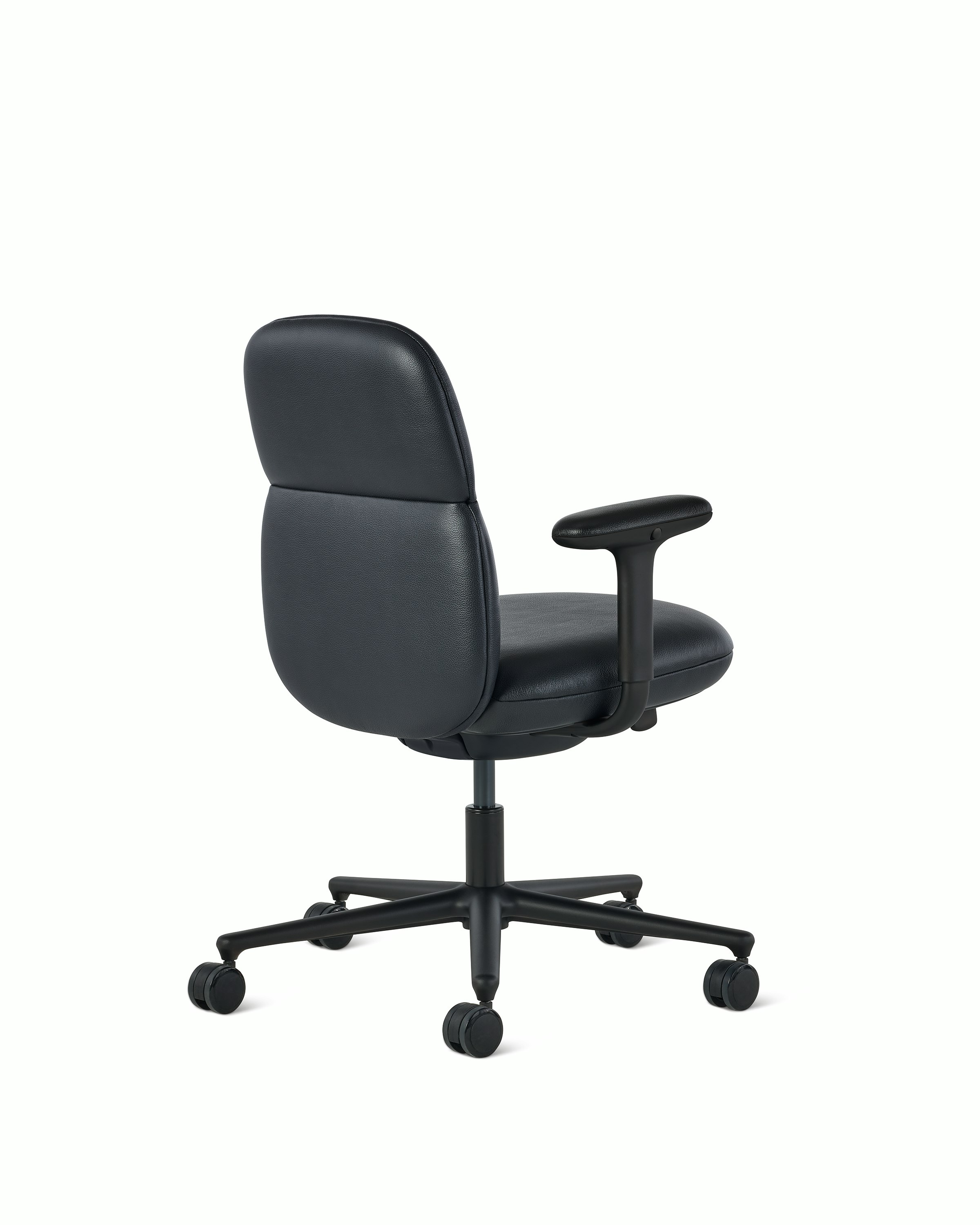 Rear angle view of a mid-back Asari chair by Herman Miller in black leather with height adjustable arms.