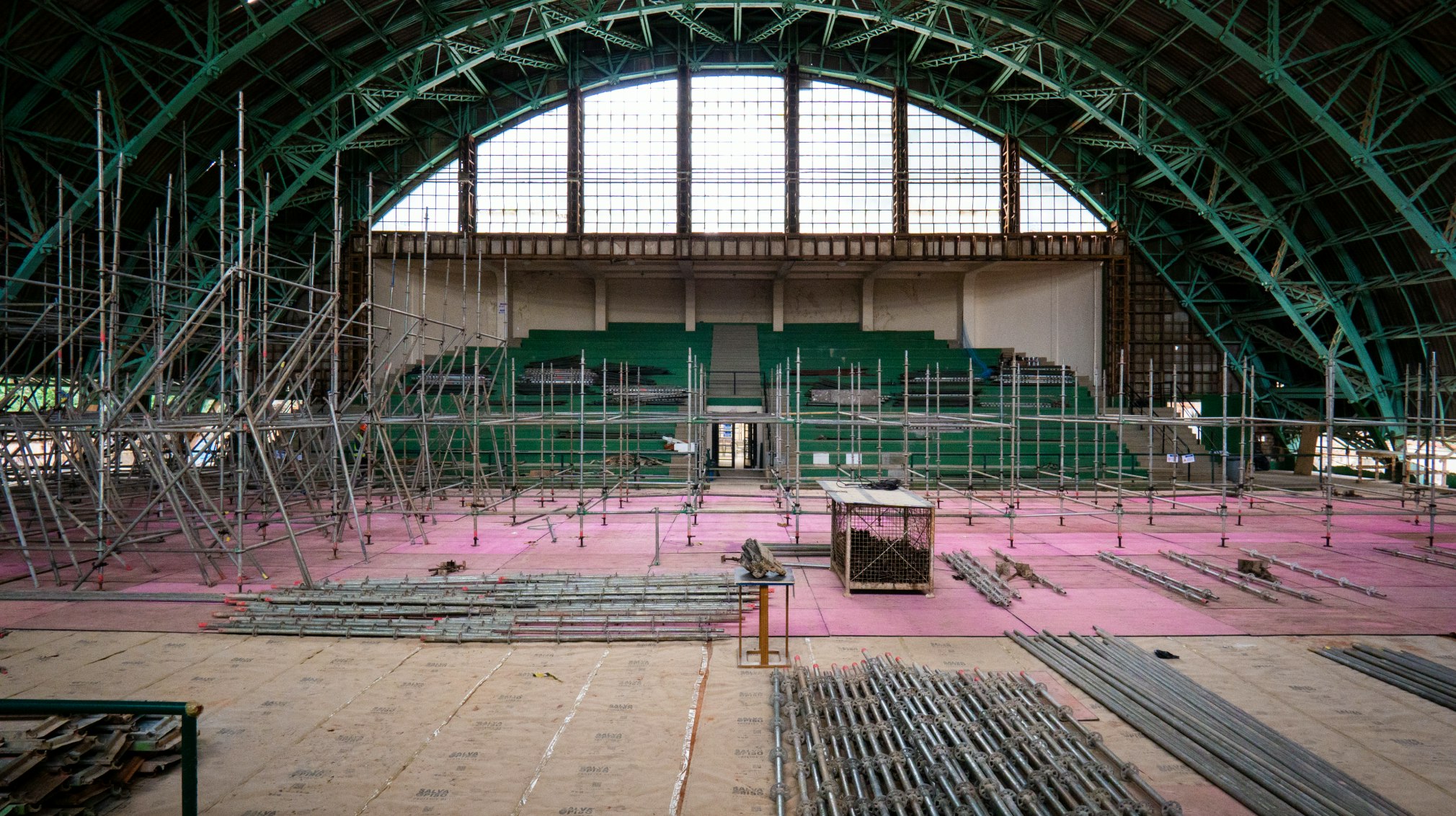 An interior construction scene showing the renovation process of the Tenis Club of the Pacaembu Sports Complex by RADDAR